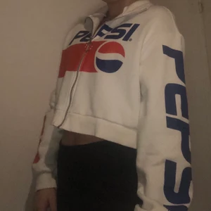 Croppad Tjocktröja  - Skönt tröja med texten Pepsi över armen och bröstet.