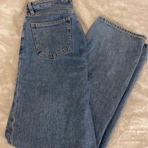 Monki jeans med hål - Ett par blåa jeans från monki i strl 25, gjort hålen själv. Buda i kommentarerna + köparen står för eventuell frakt!