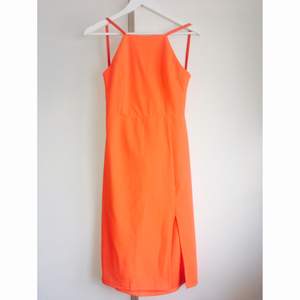Orange klänning med djup rygg. Liten i storleken. 