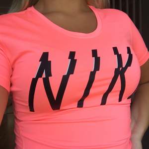 Rosa tränings t-shirt från Nike. Frigursydd med stora bokstäver.        Köpare står för frakt 