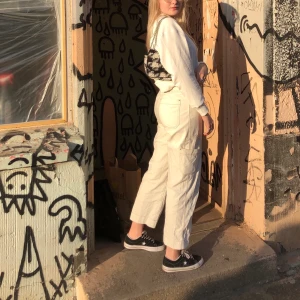 vita byxor med detaljerade sömmar - jättefina byxor från weekday, strlk 38. köptes förra året och använts kanske 10 ggr. jag är 176 cm, men på bilderna va jag runt 175 ✨ har en liten nästintill osynlig fläck på baksida av ena benet, skriv för bild! frakt exkluderat