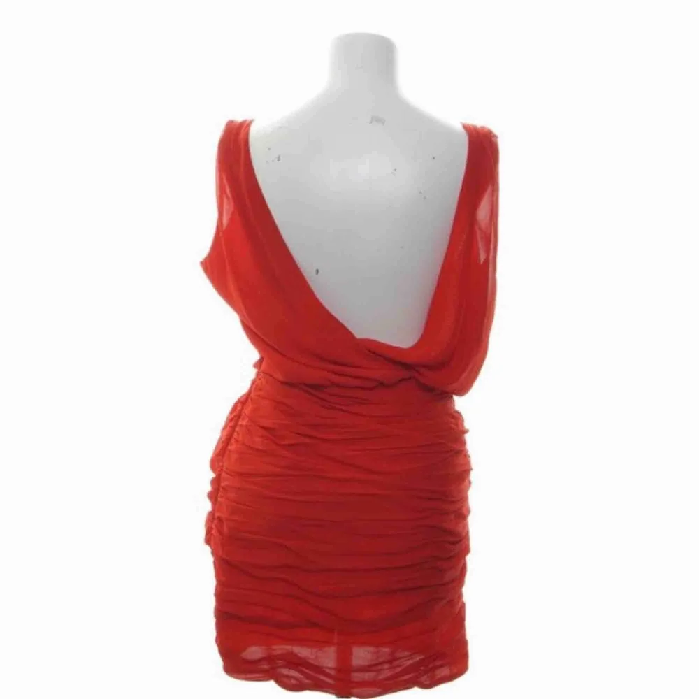 Röd cocktailklänning från Dry Lake. Köpt för 1000kr, bara använd 1 gång så superbra skick! Snygg urringning fram & bak, veckat tyg över mage och rumpa. Frakt tillkommer. Klänningar.