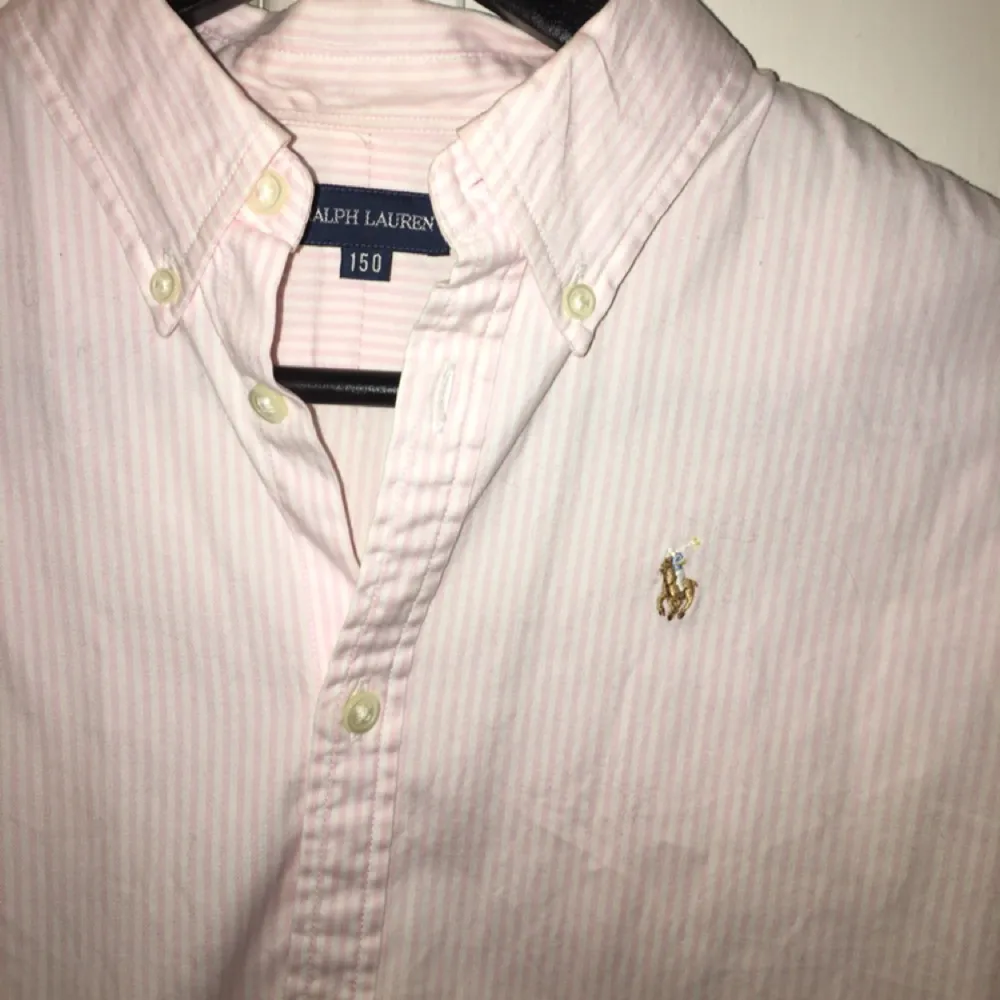 Säljer en Ralph Lauren skjorta i barnstorlek 150, men passar även en XS, dvs 32/34. Frakt ingår. Tar swish! Ljusrosa och vit.. Kjolar.