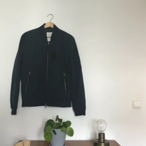  - Tunnare jacka som håller värmen relativt.  Färg: marinblå