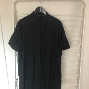 Lång kortärmad skjorta XS/S  - Svart lång kortärmad skjorta från Lager 157. Storlek XS/S. Skickar med postnords blåa kuvert