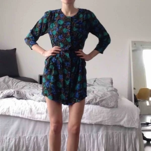 Vintageklänning blommig - Sötcool vintageklänning i stl S. Grönblått blommönster, mässingknappar längs hela framsidan. Bomullsmaterial. Luftig, skön och smickrande passform. Köpt vintage så är en unik liten pärla. Upphämtas i Malmö, casual street food. 