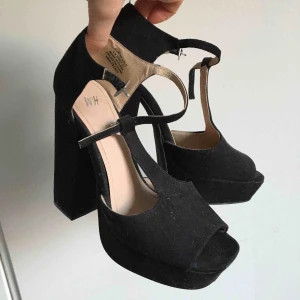  - Högklackade skor i svart. Ca 12 cm höga i bra skick