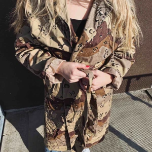  - Oanvänd kamouflagekappa från Junkyard, lappen kvar. 