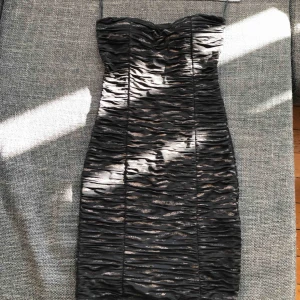  - Tiger print, gold and black, has internal padding, cup size A/B, stretchy material, 