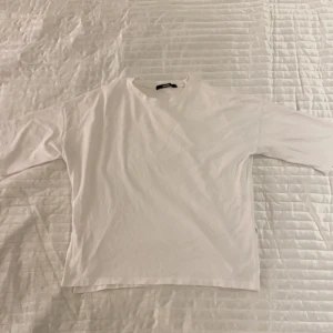 Vit topp - Vit topp/t-shirt med trekvartsärmar fråm Bikbok i strl S. Öppen nedtill på sidorna. Använd 1 gång.