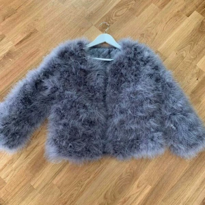 Fjäderjacka - Grå fjäderjacka endast använd en gång och är som fin! Storleken är medium men den är mer som small.