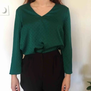Grön blus - Fantastisk grön blus i något som liknar silke. Mönstret är grön bakgrund med mörkare gröna prickar. Säljer pga använder så sällan. Köpare betalar frakt. Skriv om du undrar över något! :)