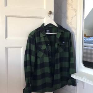 En svart och grön skjorta från Dickies. Passar som en stor S. 100% bomull och i gott skick.