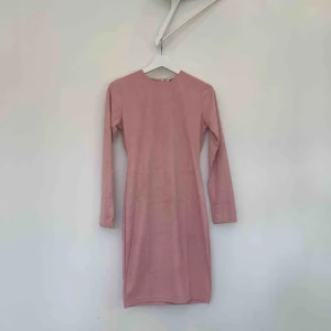  - Rosa tight klänning i mockaimitation. Oanvänd. Klänningen slutar lite ovanför knäna. Fraktar eller möts upp i Stockholm (köparen står för frakten)!