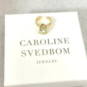 Caroline Svedbom ring - Oanvänd ring från Caroline Svedbom i ljusgul. Nypris 395kr mitt pris 150kr. Postas med det blå kuvertet från posten. 