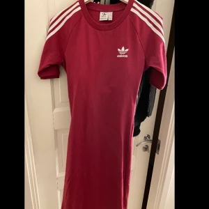 Adidas klänning - En vinröd adidas klänning som aldrig kommit till användning. Den är i storlek S men den är väldigt stretchiga. Den formar sig perfekt efter ens kroppsform. 