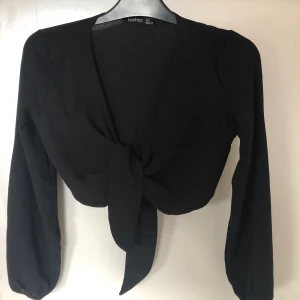 Svart croppad blus - Svart croppad blus från Boohoo, storlek 34/36, knappt använd