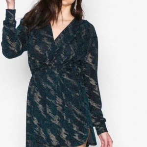  - Draped front with tie band at waist from Nelly  Color: black/blue/gold Size: small Used once 