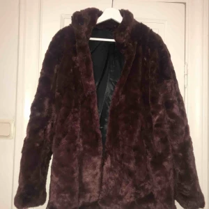  - Vinröd vinterjacka i fuskpäls. 