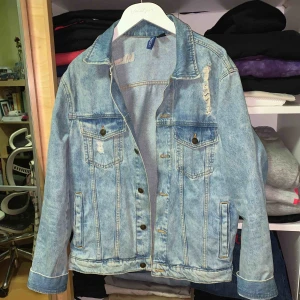 - Köpt på H&M för något år sen och inte alls använd. En ljus jeansjacka, lite oversize modell med slitningar på fram & bak stycke ! 