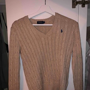  - Superfin kabelstickad tröja från POLO Ralph Lauren! Superskön i en perfekt beige färg. Som ny då den bara är använd några få gånger. Nypris på ca 1200 kr. Kan hämtas upp i Lkpg eller fraktas. Köparen står för frakten.