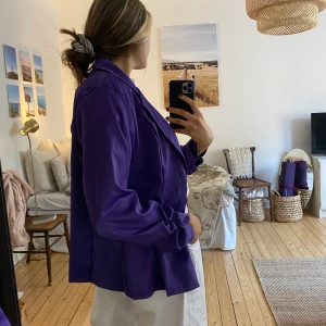 Vintage kavaj stl L - Lila kavaj från second hand. Aldrig använd av mig, men passformen är riktigt bra! Så snyggt i slutet av ärmarna och sen går den att stänga men jag föredrar att ha den öppen. Jättebra skick och ganska tunt material så perfekt för layering!