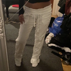 Vita lågmidjade linnebyxor med snörning - Vita midrise/lowwaist linnebyxor från Skagen clothing. Står ej vad storleken är men det är xs eller s. Har sytt till tyg nere vid foten för en vidare look. 💓💓Nypris är 900kr 