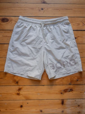 Vita Björn Borg badshorts med snörning - Snygga vita badshorts från Björn Borg. Oanvända har endast testats. Säljer de de inte passade