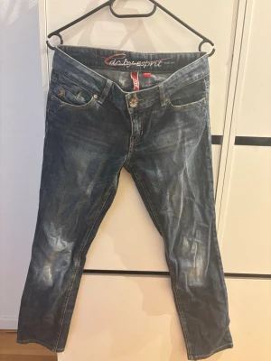 Blå jeans från Esprit, modell FIVE - Snygga blå jeans från Esprit, modell FIVE, med klassisk femficksdesign och slitna detaljer. Jeansen har normal midja och raka ben. Tillverkade i denim med en cool tvättad look och kontrastsömmar. Perfekta för en avslappnad och trendig stil.