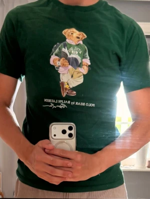 Grön Polo Bear t-shirt från Ralph Lauren - Säljer en grön t-shirt från Ralph Lauren med den ikoniska Polo Bear-trycket på bröstet. 