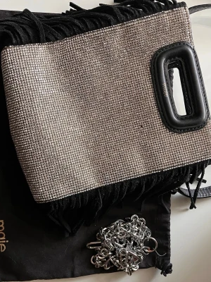 Maje axelväska/clutch med strass – Dustbag ingår - Säljer min maje väska som tyvärr inte kommer till användning🩷 den är i väldigt fint skick med nästintill inga tecken på användning🩷 det finns dustbag och den medföljande kedjan🩷
