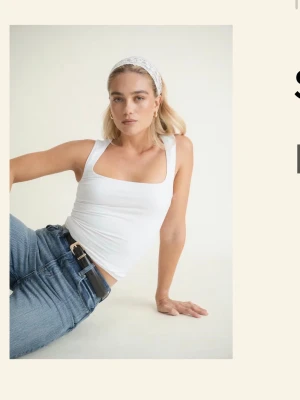Vit linnetopp med fyrkantig ringning - Snygg vit linnetopp med breda axelband och fyrkantig ringning. Perfekt att matcha med jeans eller kjol för en enkel och fräsch look. Tillverkad i mjuk bomull som känns skön mot huden. Helt ny, köpte fel storlek 