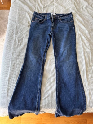 Blå bootcut jeans från 157 - Säljer ett par klassiska blå bootcut jeans från 157 med full längd. Jeansen har fem fickor, normalhög midja.