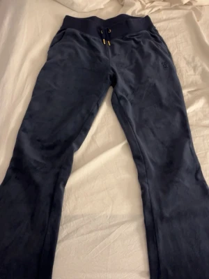 Juicy couture - Marinblått juicy set. Ingen text på rumpan. Väldigt lågmidjat. Tröjan är i XS och byxorna i S.