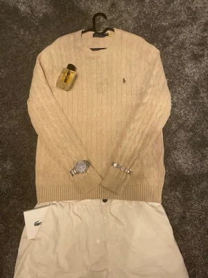 Beige kabelstickad tröja från Ralph Lauren - Sjukt snygg Ralph Lauren tröja nu till våren och sommaren. Den är i väldigt bra skick. Bara attt skriva vid frågor eller om du har ett bud!