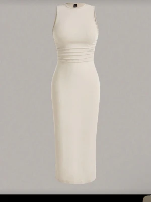 Beige ärmlös långklänning - Stilren beige långklänning med figurnära passform och markerad midja. Klänningen är ärmlös och har en enkel, elegant design. Aldrig använt den, va inte riktigt min stil fick hem den för några dagar sedan 
