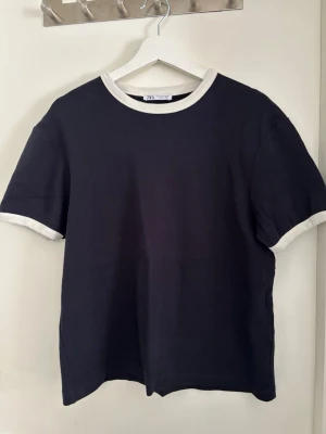 Zara T-shirt  - Säljer en unik och stilren T-shirt från Zara. Storlek M och knappt använd. Perfekt till våren / sommaren! 