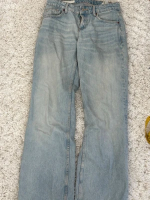 Ljusblåa raka jeans från Zara - Säljer ett par ljusblå jeans med rak passform och låg midja. Säljer pga att de är lite små i midjan!! Använda fåtal gånger så inga defekter! Jeansen är lite skrynkliga i bilden men det går såklart att lösa!