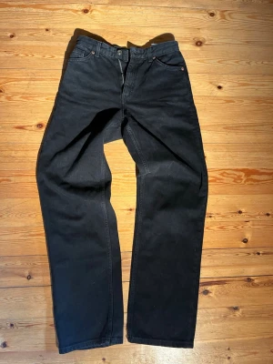 Svarta jeans från Monki - Snygga svarta vintage damjeans från monki, (taiki). möjlighet att tvätta som för snyggare wash look. Mycket bra skick. Modell: balloon leg, high waist. Strl: 26. Skriv vid eventuella funderingar😄 Passar någon runt 160 cm Midja: 34 cm Längd 98cm