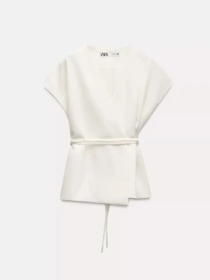 Vit omlottopp från Zara - Stilren vit omlottopp från Zara med v-ringning och knytband som går att knyta i ryggen efter önskad passform. Säljer då den är för stor💓