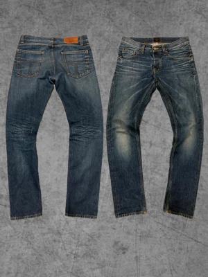 Tiger of sweden jeans - Säljer ett par blå jeans med snygga slitningar och tvättade detaljer. Jeansen har raka ben, fem fickor och klassisk knappgylf. Passar perfekt till en avslappnad streetstil och har en cool vintagekänsla. Storlek 31/32.