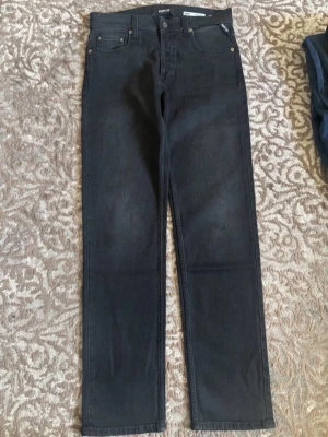  Replay jeans svarta - Snygga svarta jeans från Replay med rak passform och klassisk femficksdesign. Jeansen har en diskret tvättad look och är tillverkade i ett mjukt denimtyg. Perfekta för dig som gillar en clean och stilren stil.
