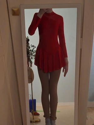 Röd konståkningsklänning - Säljer denna basic konståkningsklänningen från märket iEFiEL köpt från Joom för ca 200kr. Strl 158/164 (13-14 år) Använt på tävling 1 gång så den är nästan helt ny. Säljer pga den är lite för liten och jag har köpt nya klänningar.