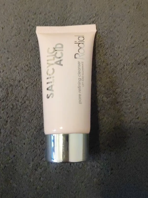 Rodial Salicylic Acid Cleanser - Rodial Salicylic Acid pore refining cleanser i en ljusrosa tub med silverfärgat lock. Rengöringen är framtagen för att förfina porerna och ge huden lyster. Tuben är smidig och enkel att använda, perfekt för daglig hudvårdsrutin.