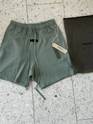 Grön/Turkos shorts Essentials Fear of God - Essentials shorts i en unik färg perfekt till sommaren. Storlek S. Pris kan diskuteras vid snabb affär. Original tags och Essentials påse medföljer