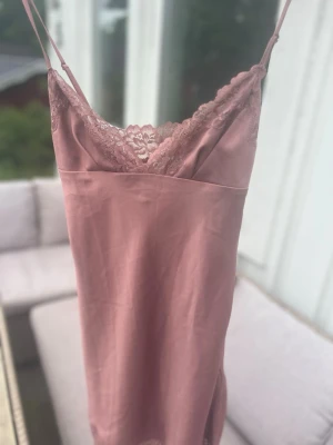 House of cb - NIA Rose Pink Satin & Lace Slip Dress - Cut from our luxuriously fluid duchess satin, 'Nia' is a sexy slip dress that's perfect for romantic date nights. The delicate shoulder straps adjust and it features a sexy plunge neckline with pretty lace edging.  Cup size: plus cup