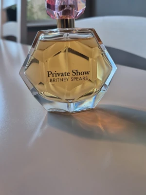 Britney Spears Private Show - Private Show från Britney Spears är discontinued och går ej att beställa längre. Denna beskrivs på följande sätt: Den öppnar upp med söta och friska noter av klementin, nektarin och kaffe med vispad grädde. Hjärtat blandar lyxiga noter av dulce de leche med vita blommor av apelsin och sambac jasmin. Den varma basen består sedan av lysande amber och sensuell mysk. Har förvarats svalt & mörkt. 100ml från början och inte mycket använd. 