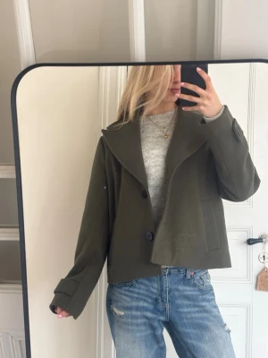 Supersnygg grön kappa - Säljer denna supersnygga mörkgröna korta kappan från Vila💗 Knqppt använd och perfekt nu till våren💗