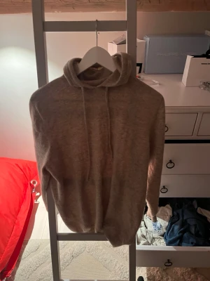 Beige hoodie i mjukt material - Tja! Säljer en beige hoodie med huva och dragsnören från hm. Hoodien har en avslappnad passform och är tillverkad i ett mjukt, stickat material som känns skönt mot huden. Perfekt för dig som gillar en enkel och stilren look. Tröjan är i jätte bra skick och är i storlek m. Säljer för jag växt ut den. Passar bäst dig som är. Skriv om ni har några frågor priset går att diskutera 