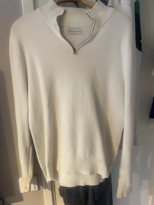 Vit stickad tröja med half zip - Vit stickad tröja från These glory days (VOLT) med half zip och hög krage. Tröjan har en clean och stilren look med lång ärm och ribbade muddar. Storlek small, skick 7/10. Pris kan diskuteras!